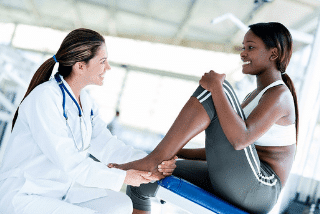 Therapist assessing the foot and heal of a patient